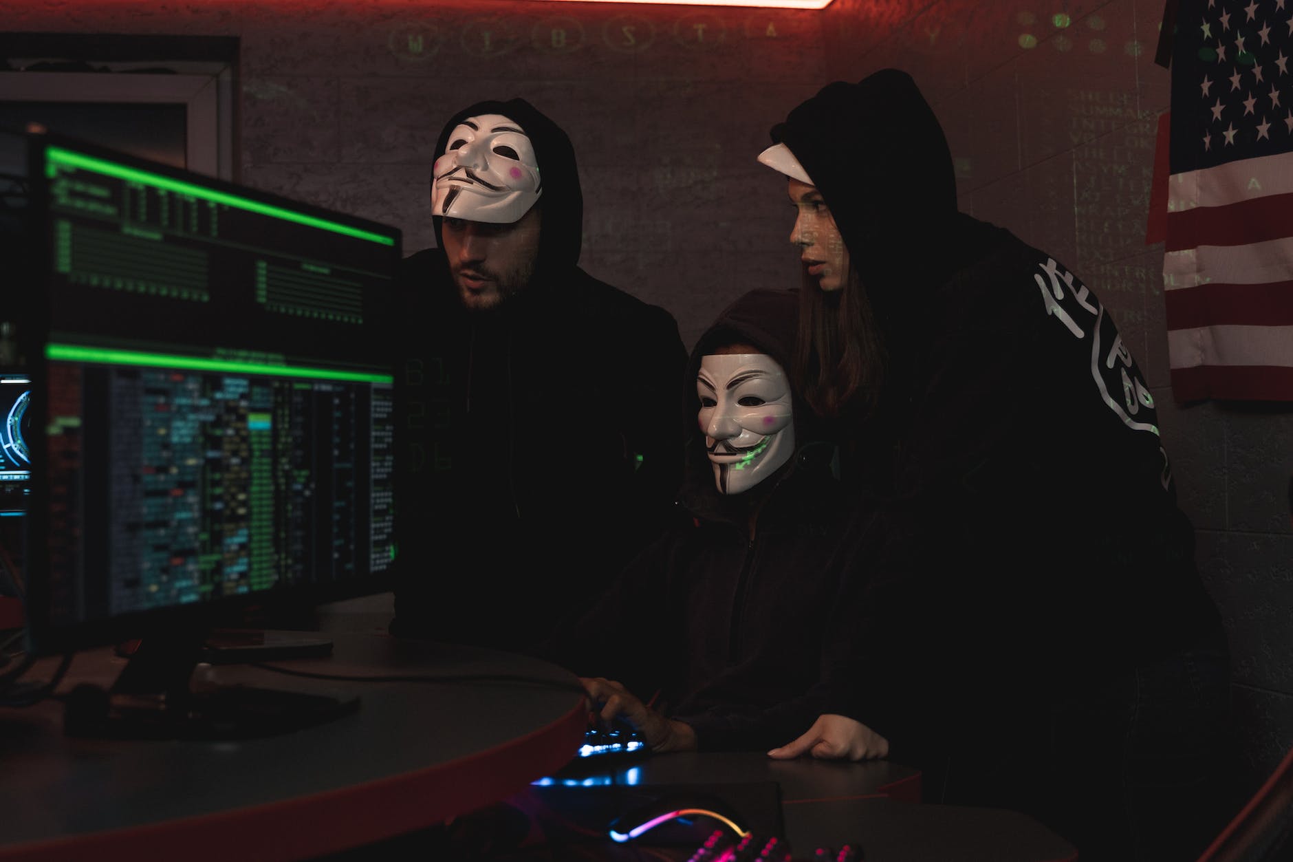 three people hacking a computer system